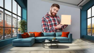 Cheerful bearded man holding copyspace blank Wall mural