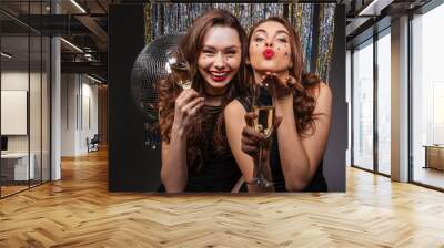 Cheerful beautiful young women having party and sending kiss Wall mural