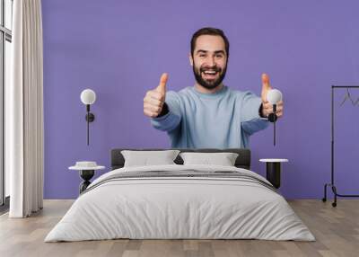 Cheerful happy young man showing thumbs up. Wall mural