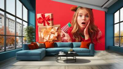 Cheerful little girl wearing Christmas raindeer costume Wall mural