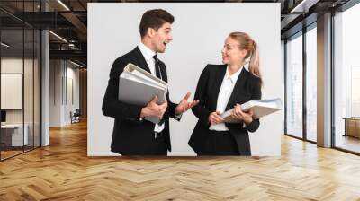 Cheerful young business couple standing isolated Wall mural