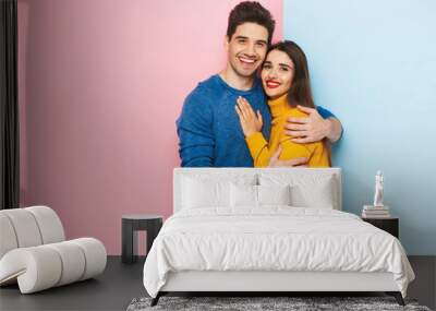 Cheerful young couple standing Wall mural