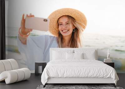 Cheerful young girl in summer hat Wall mural