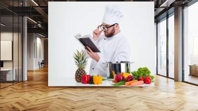 chef cook in glasses reading recipe book Wall mural