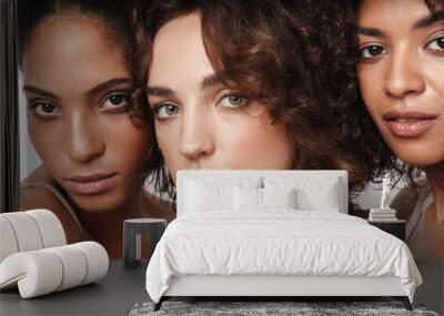 Close up beauty portrait of three attractive young sensual multiethnic women Wall mural