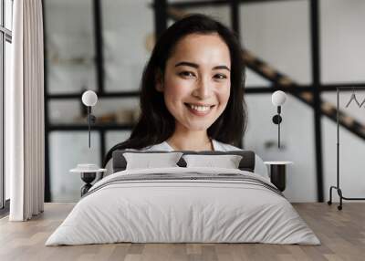 Close up of a confident smiling young asian business woman Wall mural