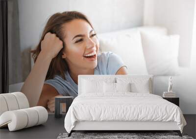 Close up of a laughing young woman Wall mural