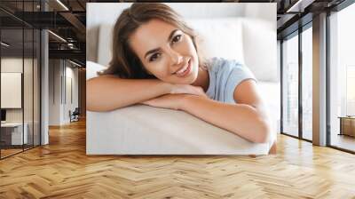 Close up of a smiling young woman relaxing Wall mural