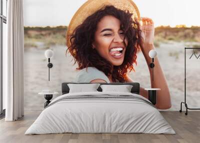 Close up of cheerful young african girl in summer hat Wall mural