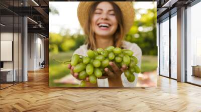 Close up of laughing young girl in summer hat Wall mural