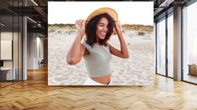 Close up of smiling young african girl in summer hat Wall mural