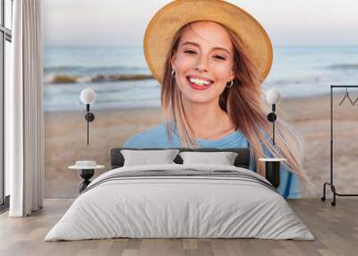 Close up of smiling young girl in summer hat Wall mural