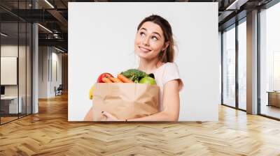 Close up portrait of a happy pretty girl holding bag Wall mural