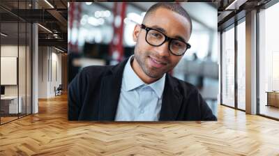 Close-up portrait of a smiling businessman in glasses Wall mural