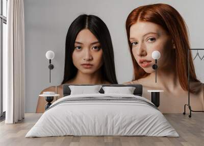 Close up studio portrait of two beautiful young girls Wall mural