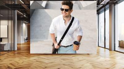 Confident businessman dressed in shirt walking upstairs Wall mural