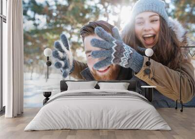 Couple having fun in winter park Wall mural