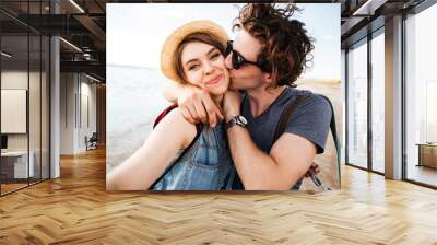 Couple kissing and taking selfie outdoors Wall mural