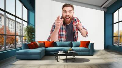 excited bearded man in checkered shirt pointing fingers at camera Wall mural