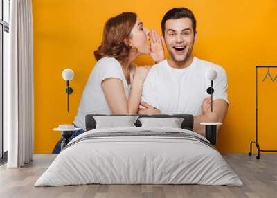 Excited beautiful couple wearing white t-shirts standing Wall mural