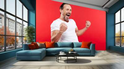 Excited happy adult man make winner gesture. Wall mural