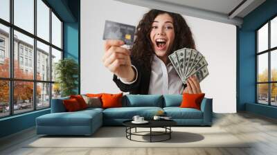 Excited happy young business woman with credit card and money. Wall mural