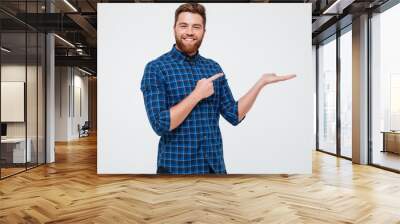 excited smiling bearded man pointing finger Wall mural