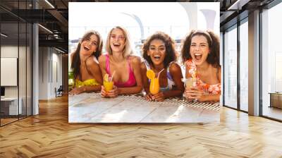 Four happy young women in swimwear Wall mural