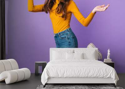 Full length image of young beautiful woman smiling and throwing up arms Wall mural