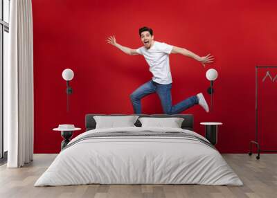 Full length portrait of an excited young man Wall mural