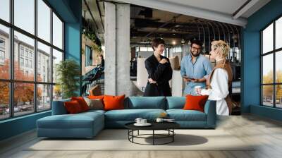 Group of colleagues having discussion during meeting in office space Wall mural