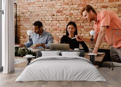 Group of colleagues working together in office Wall mural