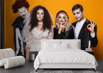 Group of friends dressed in scary costumes celebrating Wall mural