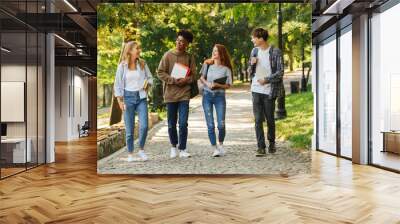 Group of happy students walking at the campus Wall mural