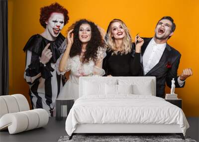 Group of laughing friends dressed in scary costumes Wall mural