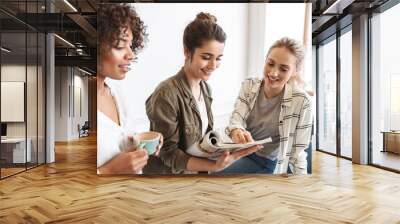 Group of multiethnic cheerful young women Wall mural