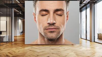 Handsome concentrated mature man. Eyes closed. Wall mural