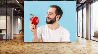 Handsome young bearded man wearing t-shirt standing Wall mural