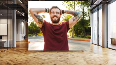 Handsome young man dressed in casual clothing Wall mural