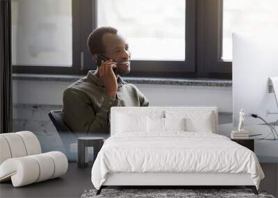 Happy african man speaking on his mobile phone Wall mural