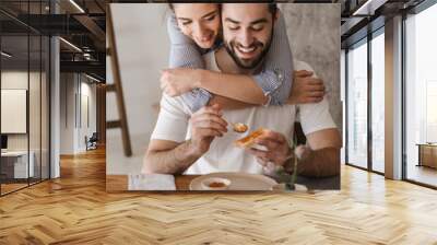 Happy cheerful couple having tasty breakfast Wall mural