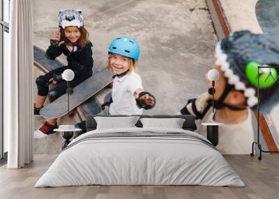 Happy cheerful kids with skateboards at the ramp Wall mural