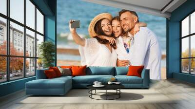 Happy family spending good time at the beach together Wall mural