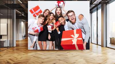 Happy funny young people holding gift boxes and having fun Wall mural