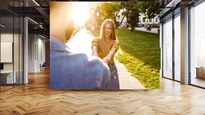 Happy lovely young couple in love spending time outdoors Wall mural