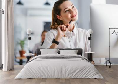 Happy pensive young businesswoman Wall mural