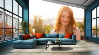 Happy pretty redhead girl with long hair Wall mural