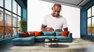 Happy young african man using tablet computer. Wall mural