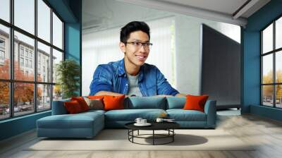 happy young asian man working at office Wall mural