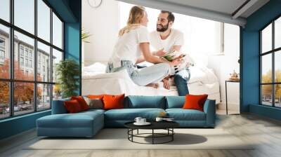 Happy young couple in love relaxing on a couch Wall mural